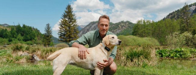 Ben Fogle outside with a dog wearing a Tractive Smart Dog Tracker