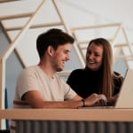 People sitting on a high table in a coworking area.